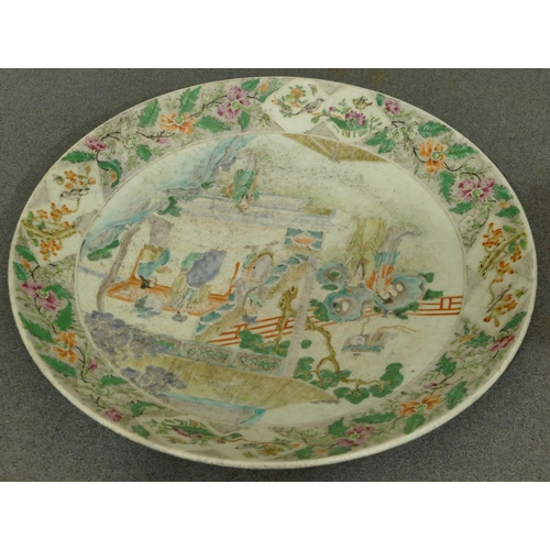 144 - A 19th Century Oriental charger with multi-coloured figure, bird, floral, leaf and scroll decoration... 