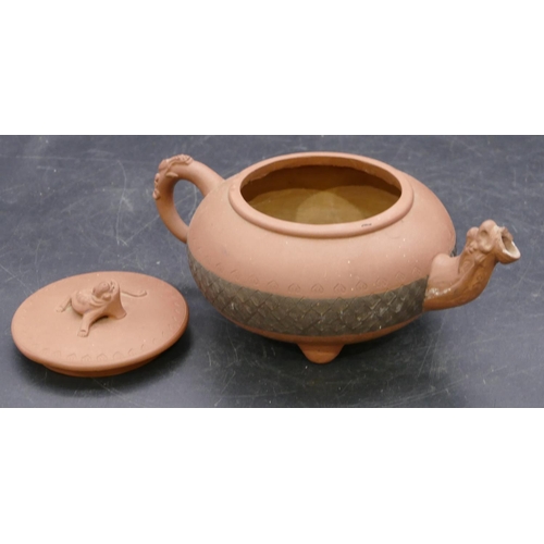 145 - A Chinese terracotta round bulbous shaped teapot with animal finial, 20cm long overall, 10cm high.