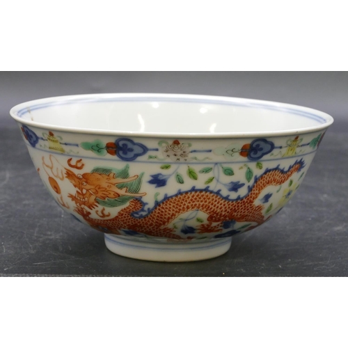 147 - A Chinese round trumpet shaped bowl on white ground with coloured dragon, phoenix and floral decorat... 