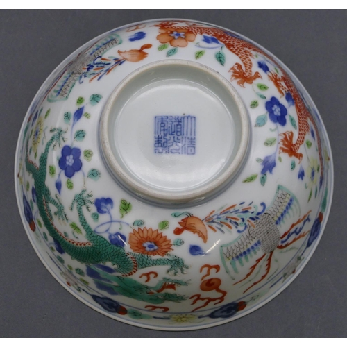 147 - A Chinese round trumpet shaped bowl on white ground with coloured dragon, phoenix and floral decorat... 