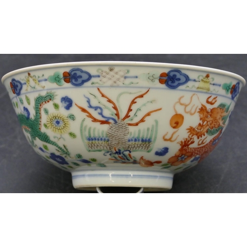 147 - A Chinese round trumpet shaped bowl on white ground with coloured dragon, phoenix and floral decorat... 