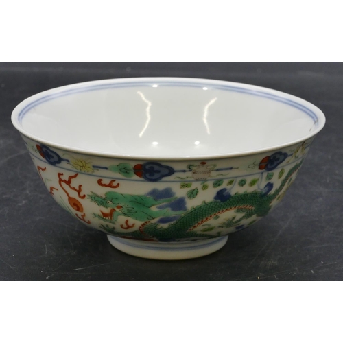 147 - A Chinese round trumpet shaped bowl on white ground with coloured dragon, phoenix and floral decorat... 