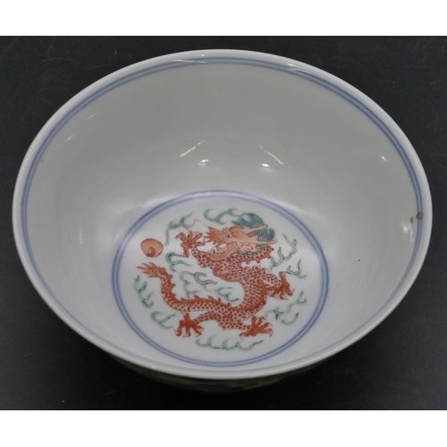 147 - A Chinese round trumpet shaped bowl on white ground with coloured dragon, phoenix and floral decorat... 