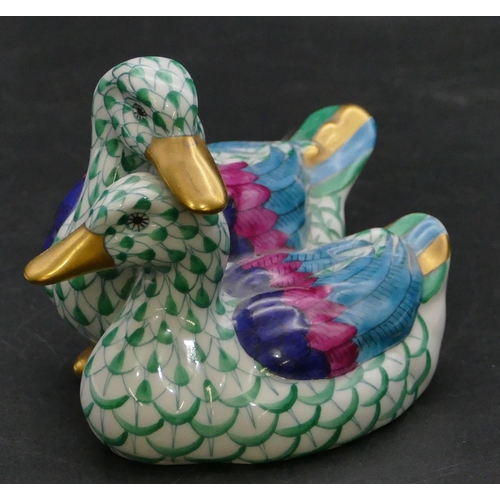 15 - A Herend group of 2 ducks on white and green ground, 11.2cm wide.