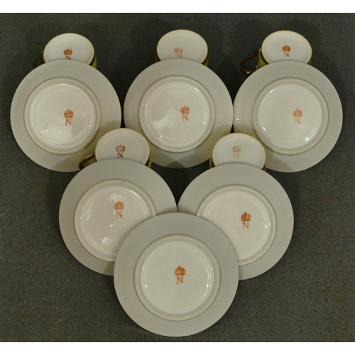 151 - A set of 5 Naples porcelain coffee cans, 6 saucers on white and yellow ground with black and white f... 