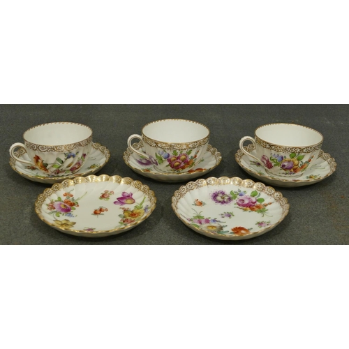 153 - A set of 3 Dresden tea cups and 5 matching saucers with crinkled rims on white ground with multi-col... 