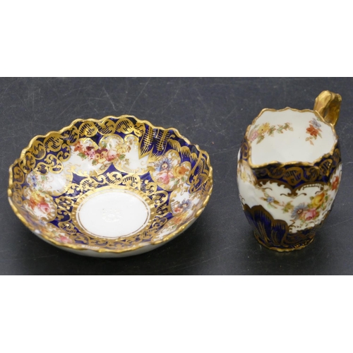 163 - A Crown Staffordshire miniature china jug and bowl on white and royal blue ground with multi-coloure... 