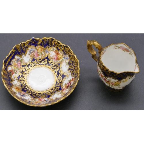 163 - A Crown Staffordshire miniature china jug and bowl on white and royal blue ground with multi-coloure... 