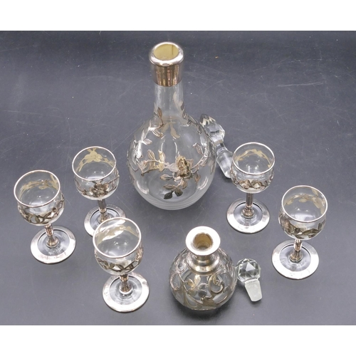 168 - A clear glass and silver mounted round bulbous thin necked liqueur decanter with stopper having rais... 