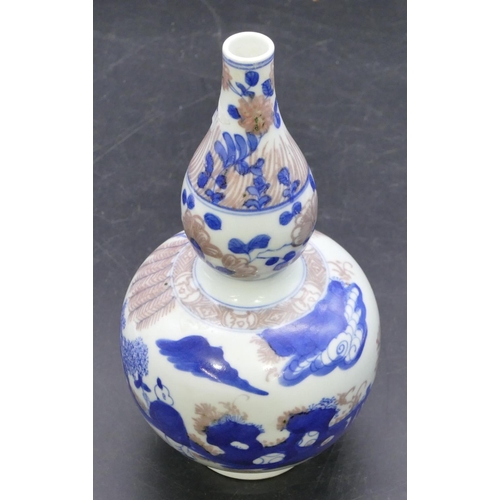 172 - An Oriental gould shaped vase on white, blue and red ground with figure decoration, 20cm high.