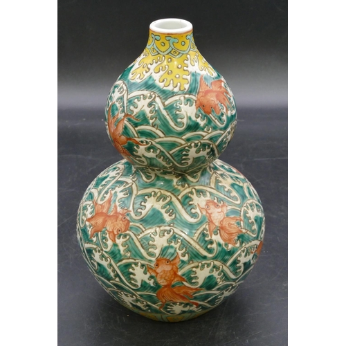 173 - An Oriental gould shaped vase on white, red and yellow ground with all over fish decoration, 23cm hi... 