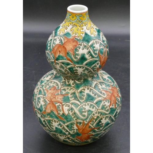 173 - An Oriental gould shaped vase on white, red and yellow ground with all over fish decoration, 23cm hi... 