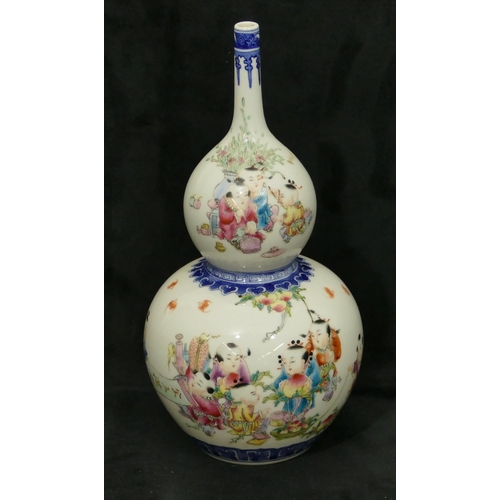 175 - An Oriental gould vase on white and blue ground with multi-coloured decoration of children, 29cm hig... 