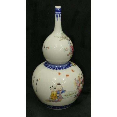 175 - An Oriental gould vase on white and blue ground with multi-coloured decoration of children, 29cm hig... 