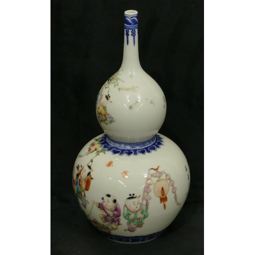 175 - An Oriental gould vase on white and blue ground with multi-coloured decoration of children, 29cm hig... 