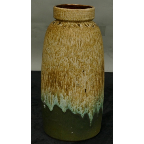 178 - A German glazed earthenware round bulbous shaped thin necked vase on green and brown ground, 38cm hi... 