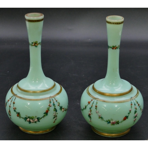 181 - A pair of 19th Century opaline glass round bulbous thin necked vases on green ground with hand paint... 