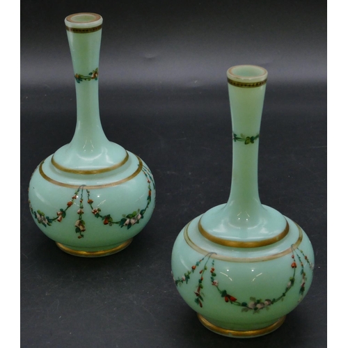 181 - A pair of 19th Century opaline glass round bulbous thin necked vases on green ground with hand paint... 