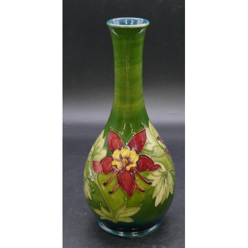 186 - A Moorcroft round bulbous thin necked vase on green ground with multi-coloured floral and leaf decor... 