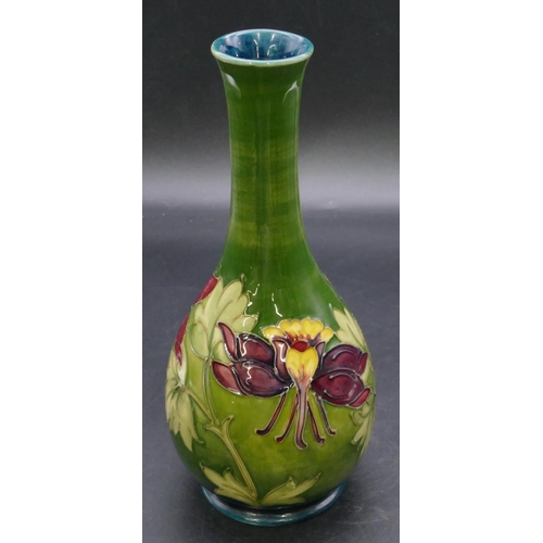 186 - A Moorcroft round bulbous thin necked vase on green ground with multi-coloured floral and leaf decor... 