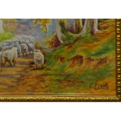 190 - F Clark rectangular porcelain plaque depicting shepherd and sheep in country lane, signed, in gilt f... 