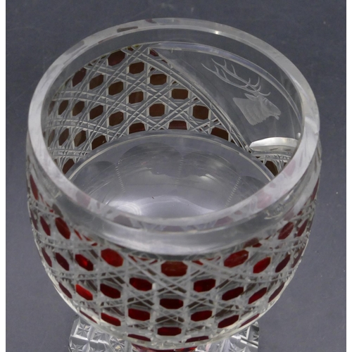 194 - A ruby and clear cut glass round trumpet shaped tumbler with engraved stags head motif on bulbous st... 