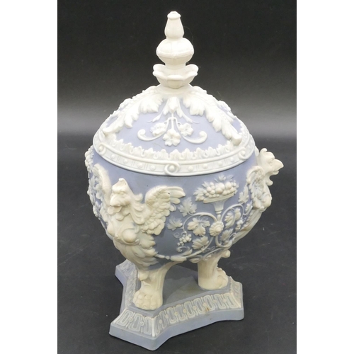 20 - A blue and white Bisque round bulbous lidded pot with raised bird, fruit, floral, leaf and scroll de... 