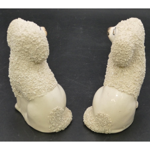 22 - A pair of 19th Century small Staffordshire figures of seated spaniels on white ground with encrusted... 