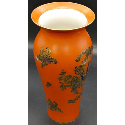 24 - A Masons round bulbous thin necked trumpet shaped vase on orange ground with blue and gilt dragon de... 