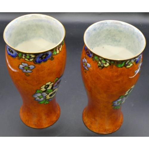 25 - A pair of Regal Ware round bulbous thin necked trumpet shaped vases on orange ground with multi-colo... 