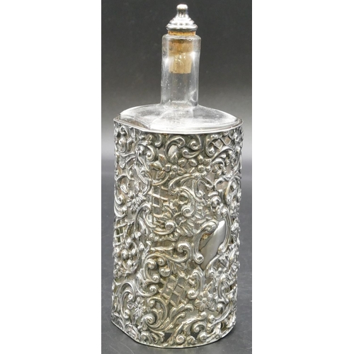 281 - A plain glass vinegar bottle in Birmingham silver frame with embossed and pierced floral, leaf and s... 