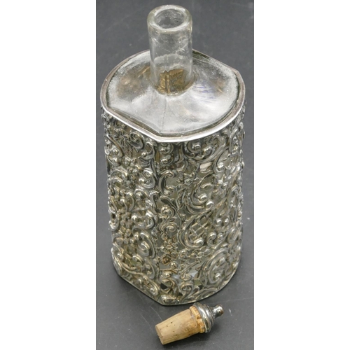 281 - A plain glass vinegar bottle in Birmingham silver frame with embossed and pierced floral, leaf and s... 