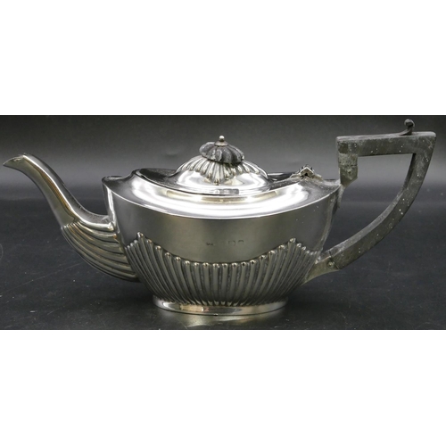 284 - A Birmingham small silver oval teapot with half embossed reeded decoration, ebonised handle and fini... 