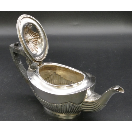 284 - A Birmingham small silver oval teapot with half embossed reeded decoration, ebonised handle and fini... 