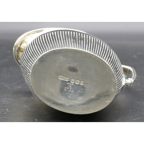 286 - A Sheffield silver oval milk jug with half embossed reeded decoration, makers mark J.D & S. 4oz.