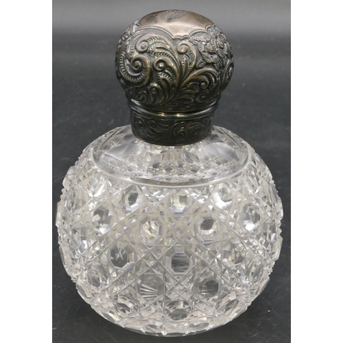 293 - A cut glass round bulbous shaped scent bottle with Birmingham silver screw lid with embossed decorat... 