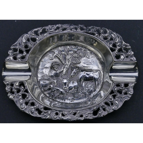 303 - 2 Continental silver coloured metal small ashtrays with embossed figure decoration, largest 7.5cm wi... 