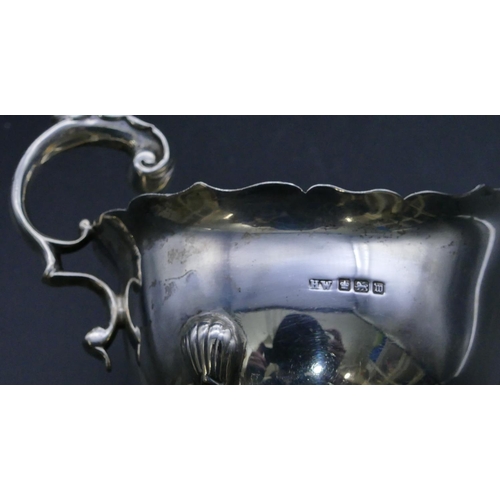 317 - A Sheffield silver sauce boat with crinkled rim, scroll handle, on splayed feet (foot missing), 5.1o... 