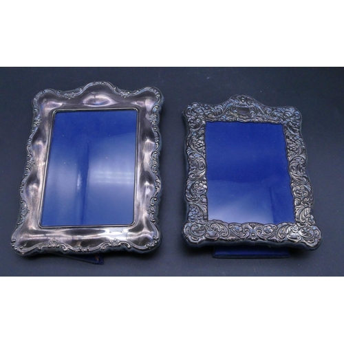 318 - A silver plated rectangular scallop shaped freestanding photograph frame with embossed floral and sc... 