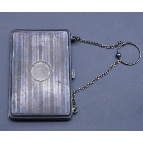 322 - A Birmingham silver mounted rectangular shaped purse with chain and engine turn decoration, hinged f... 