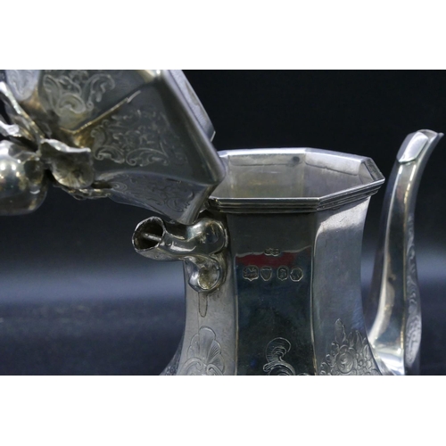 332 - An early Victorian octagonal bulbous shaped silver teapot with all over engraved decoration, London ... 