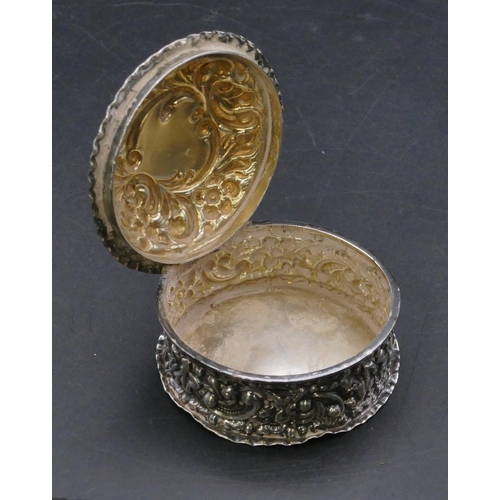 369 - A late Victorian silver round pill box with hinged lid and all over embossed floral and scroll decor... 