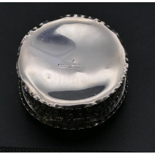 369 - A late Victorian silver round pill box with hinged lid and all over embossed floral and scroll decor... 