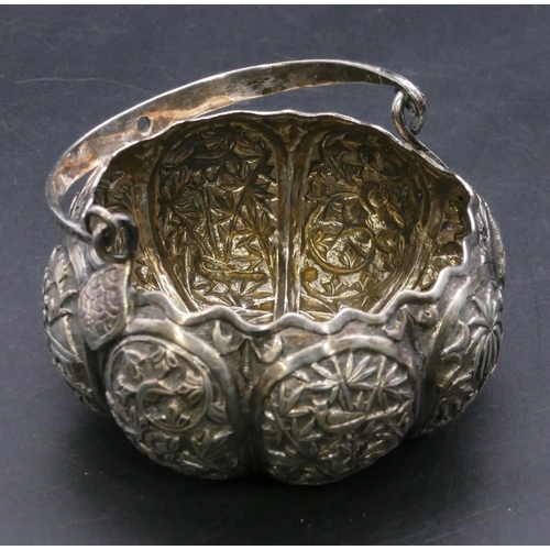 371 - An Eastern silver coloured metal round bulbous shaped sugar bowl with swing overhead handle, all ove... 