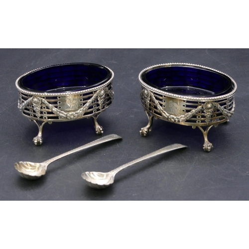 372 - A pair of George II oval silver salts with blue glass liners, pierced and raised swag galleries on c... 