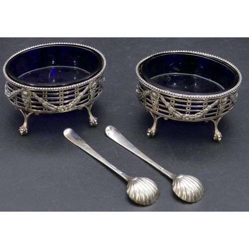 372 - A pair of George II oval silver salts with blue glass liners, pierced and raised swag galleries on c... 