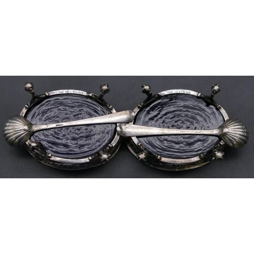 372 - A pair of George II oval silver salts with blue glass liners, pierced and raised swag galleries on c... 