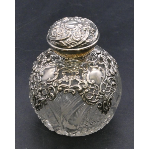 373 - A Edward VII cut glass round bulbous shaped scent bottle with silver embossed neck and cover enclosi... 