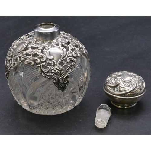 373 - A Edward VII cut glass round bulbous shaped scent bottle with silver embossed neck and cover enclosi... 