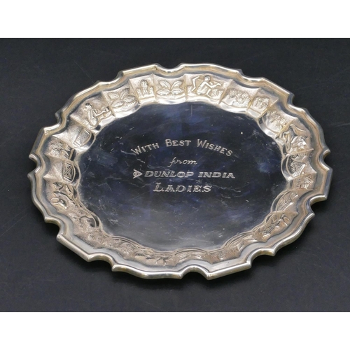 377 - A Continental silver coloured metal round pie crust card tray with embossed figure and animal motifs... 